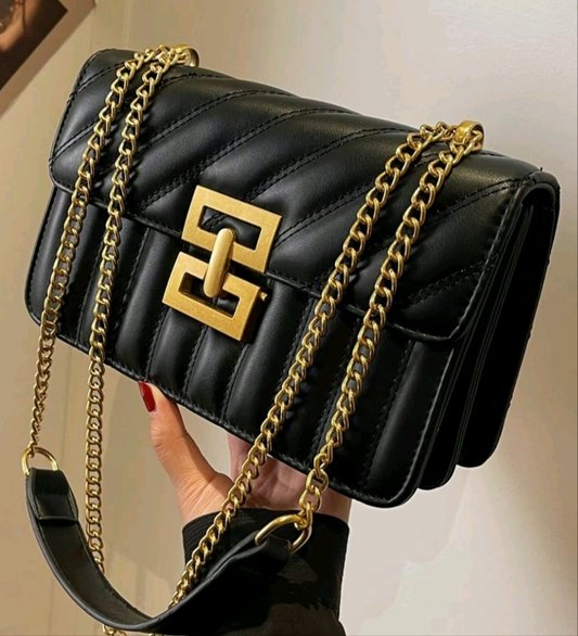Elegant black.
Crossbody, purse, gold chains and gold clasp